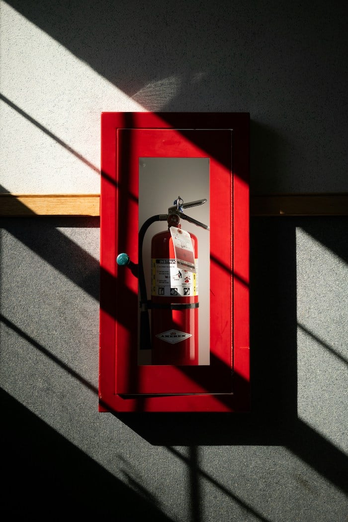 A fireplace in a glass box on the wall