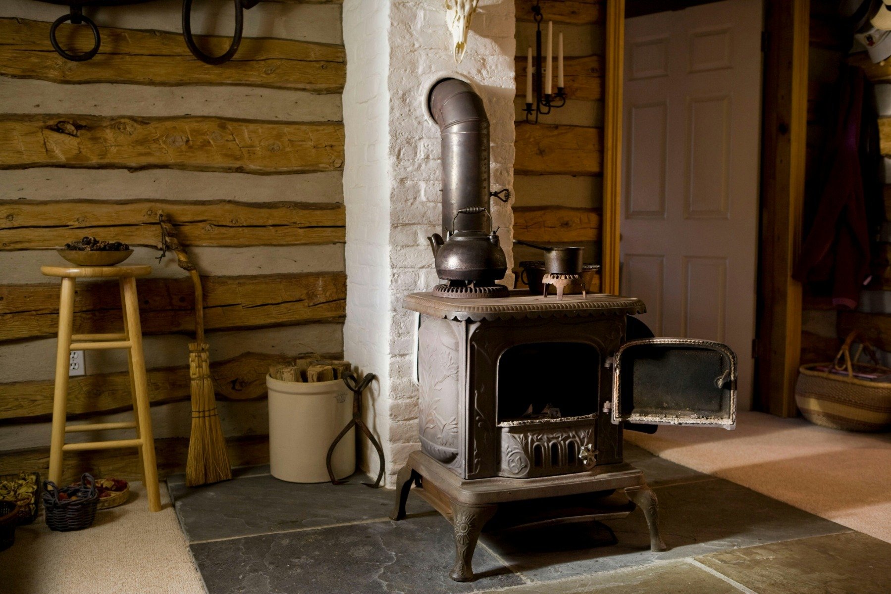 An old freestanding fireplace in a cosy looking living room