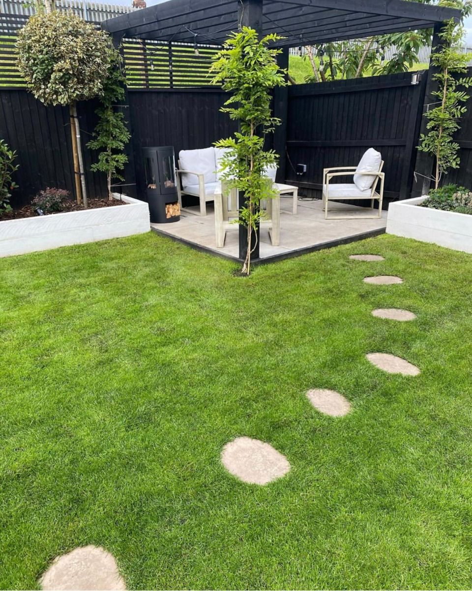 Black bioethanol fireplace positioned next to a garden sofa set