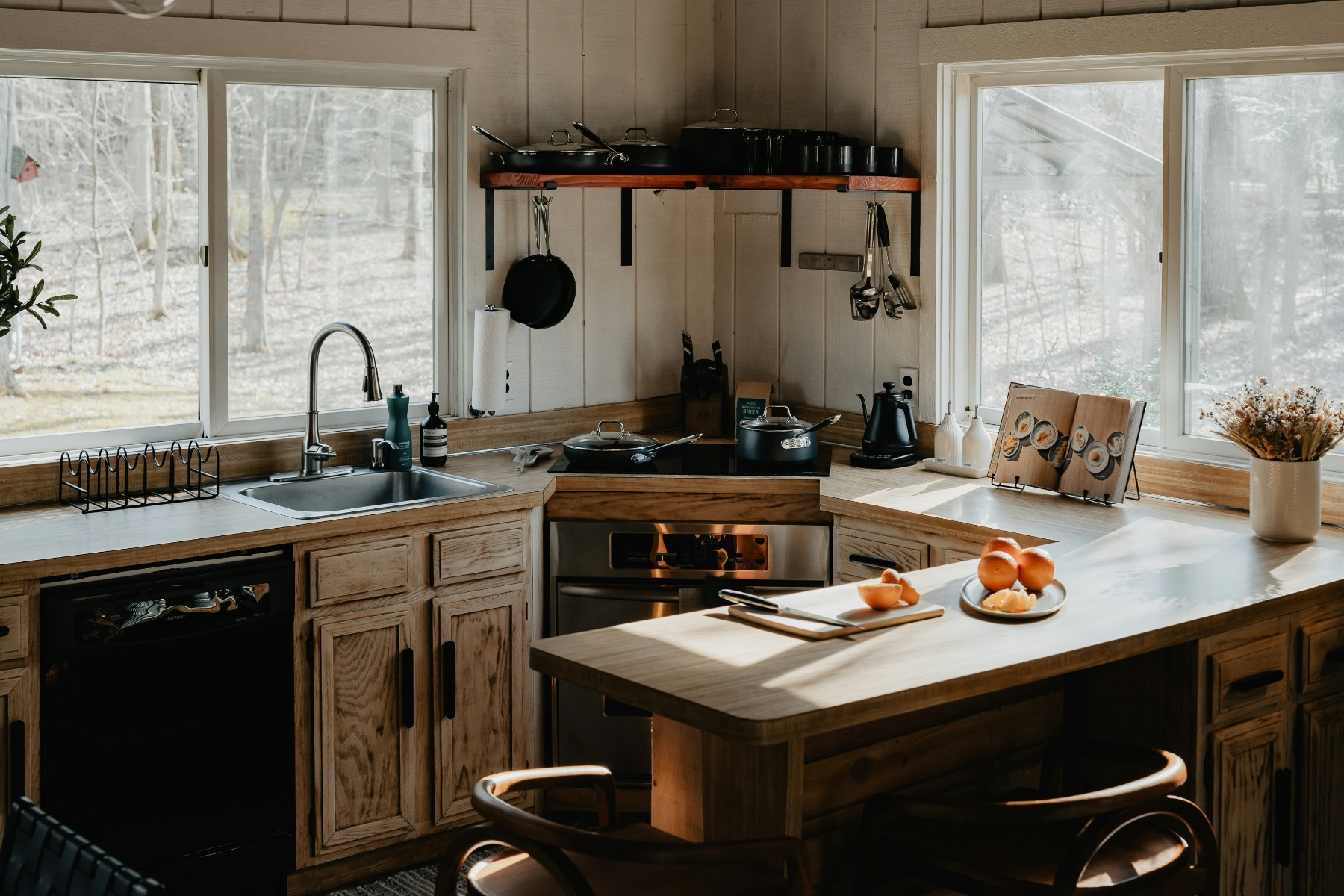 Kitchen with wooden features in a forest filled with natural light