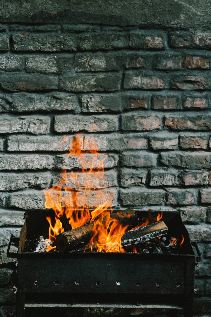 a fireplace against a brick background