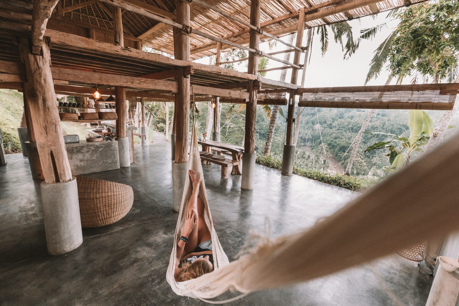 Woman relaxing in a hammock surrounded by trees