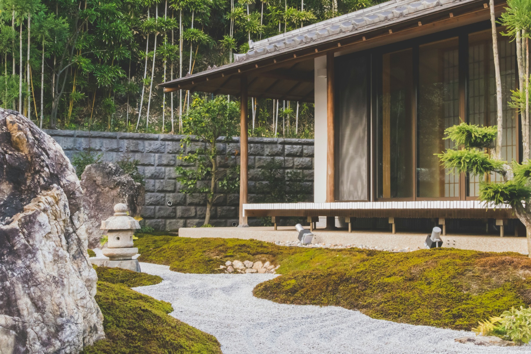 Zen garden with lots of gravel outside a wooden house