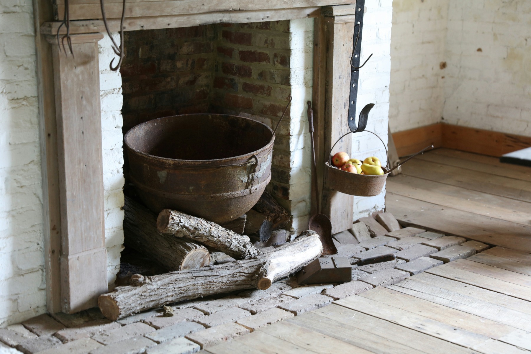 Old brick fireplace with a basket of fruits